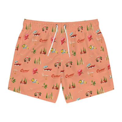 Peach-colored swim shorts with a pattern of small images and 'Como' branding on a white background.