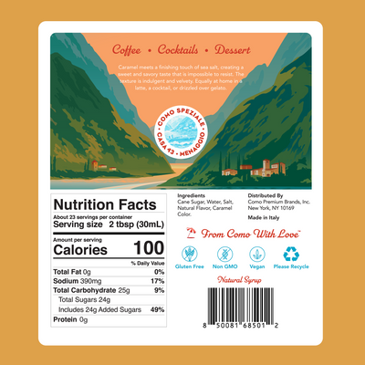 The back of a beverage can label for Como Speziale, featuring a colorful landscape illustration and detailed nutrition facts, ingredients, and a barcode on a solid orange background. Nutrition Facts of the Como Speziale Caramel Syrup. 100calories per 2 tablespoons. 