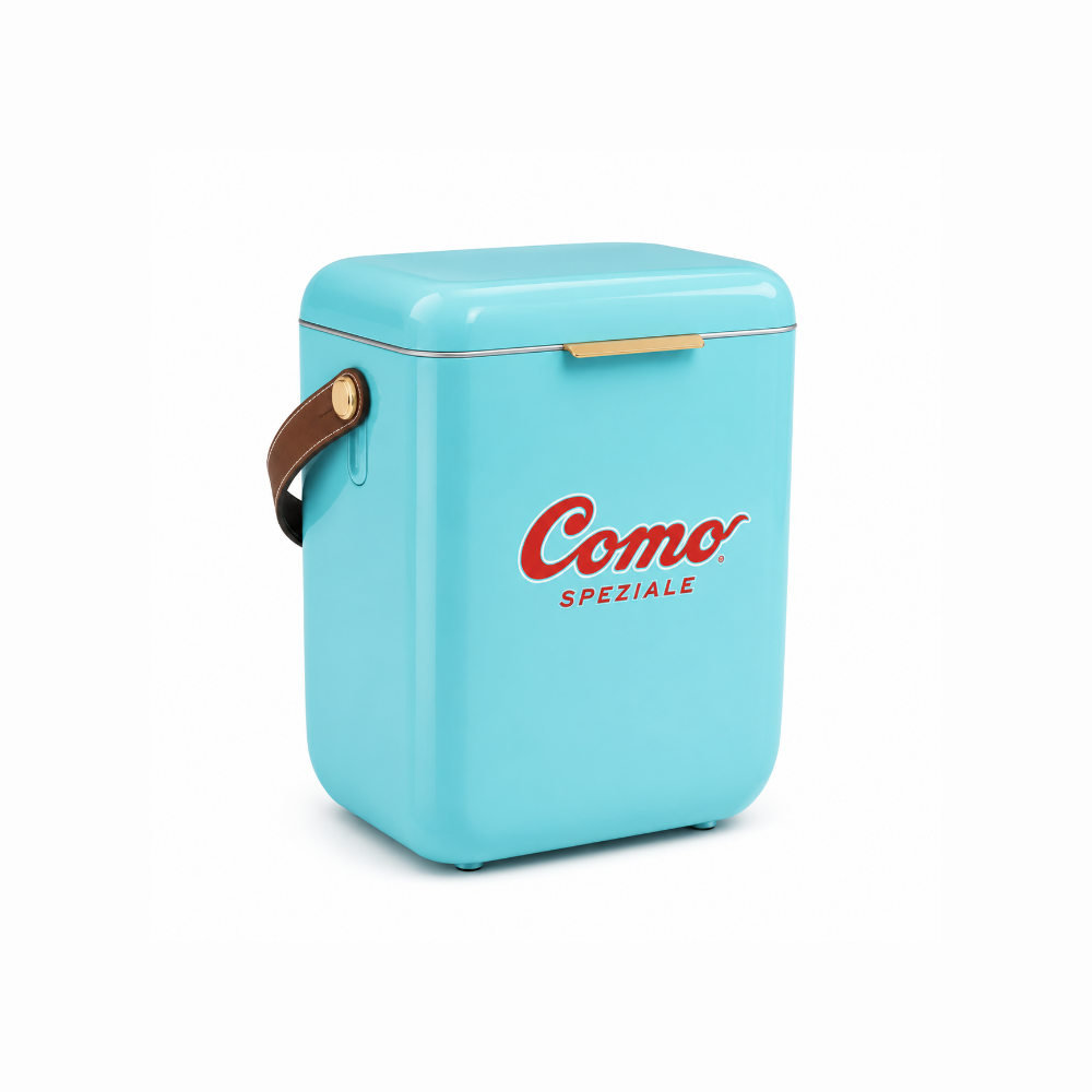A light blue retro-style mini cooler with a brown leather handle, gold metal accents, and the red 'Como Speziale' logo on the front, set against a plain white background.