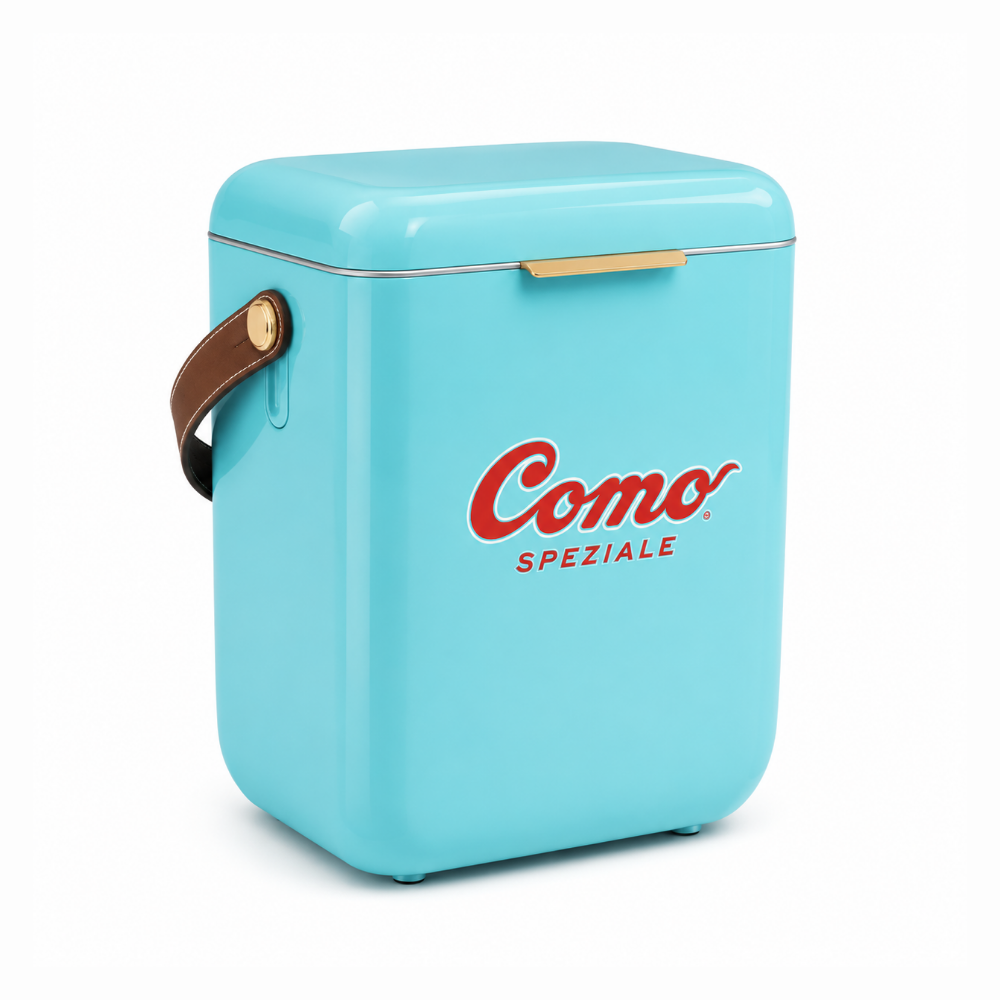 A light blue retro-style mini cooler with a brown leather handle, gold metal accents, and the red 'Como Speziale' logo on the front, set against a plain white background.